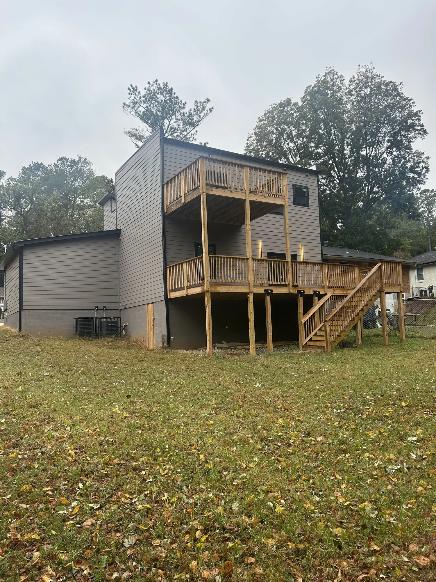 A second NirvanaDeshaun home with elevated custom decking on a wooded lot