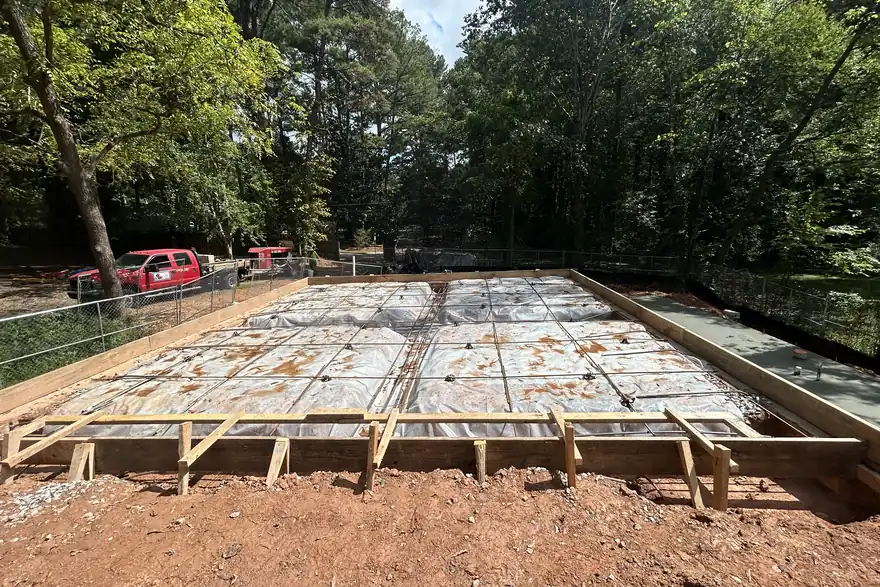Engineered floor system framed and braced across a finished foundation