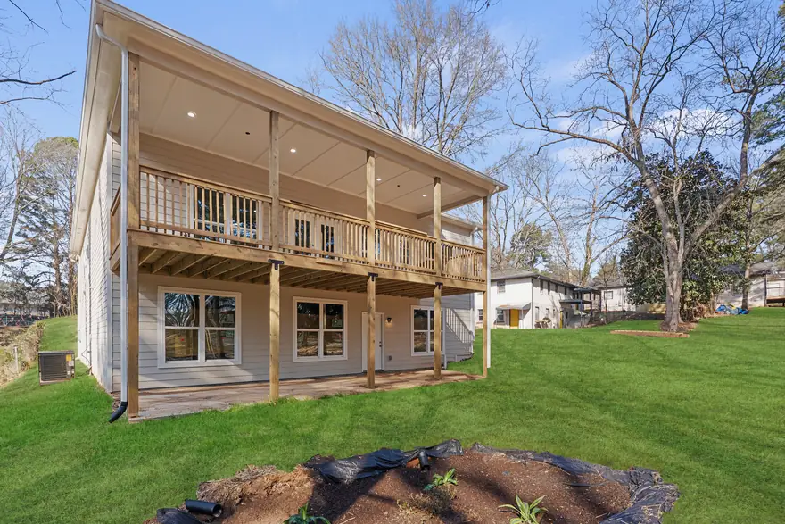 Completed NirvanaDeshaun home with a two-story covered porch and finished lawn